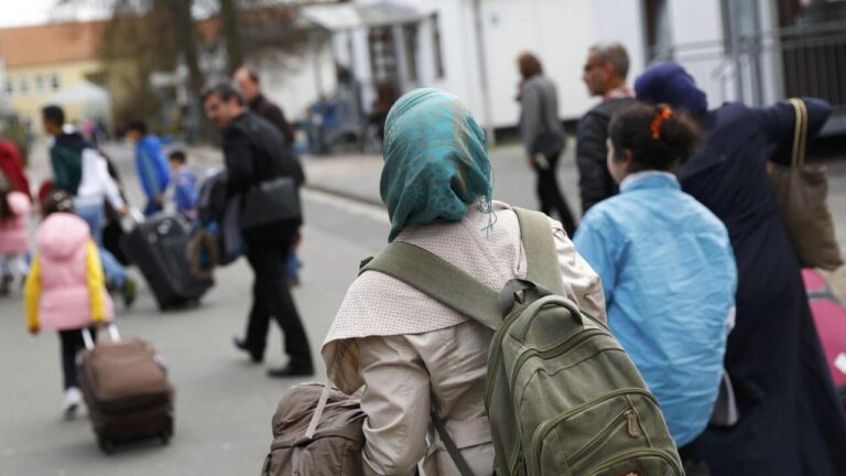 Syrian refugees arrive at the camp for refugees and migrants in Friedland